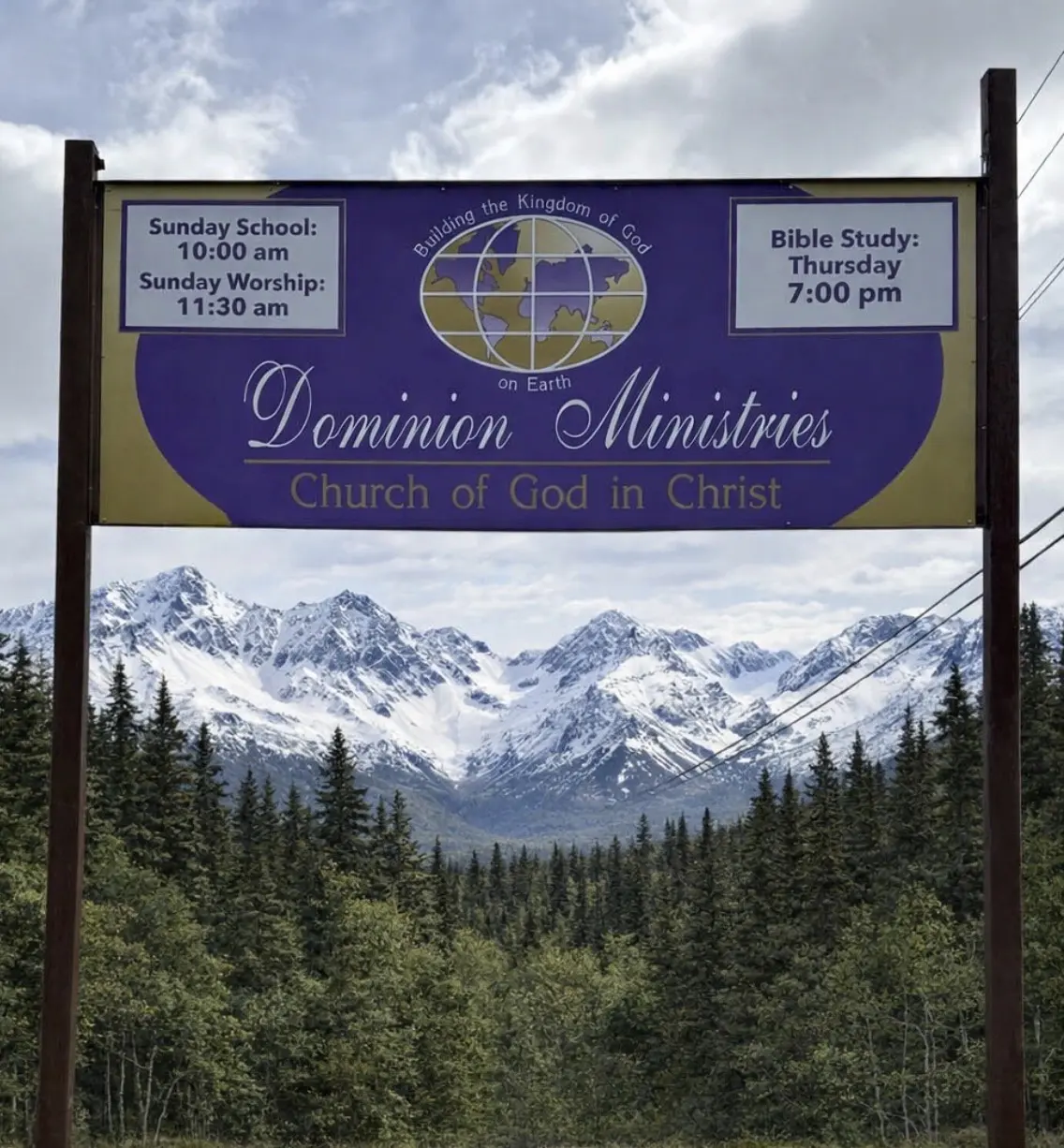 Sign for Bowman Absinthes with mountain backdrop.