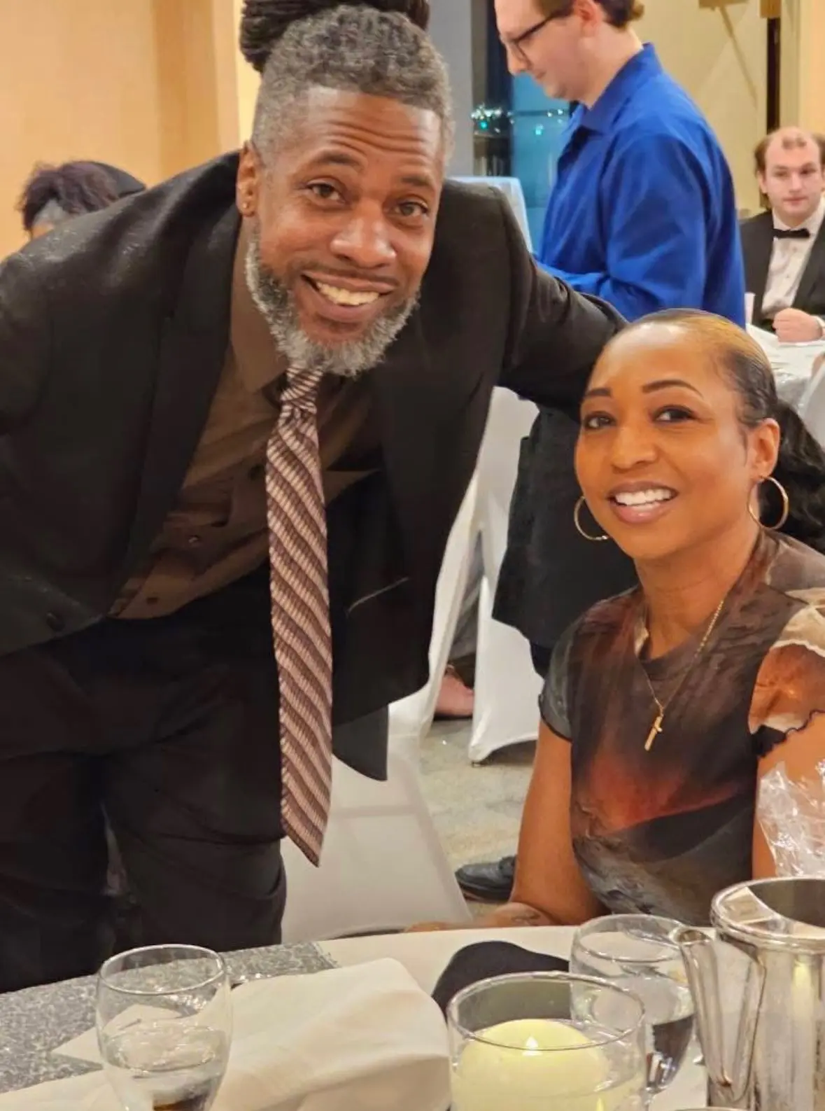 A smiling man and woman posing at a formal event.