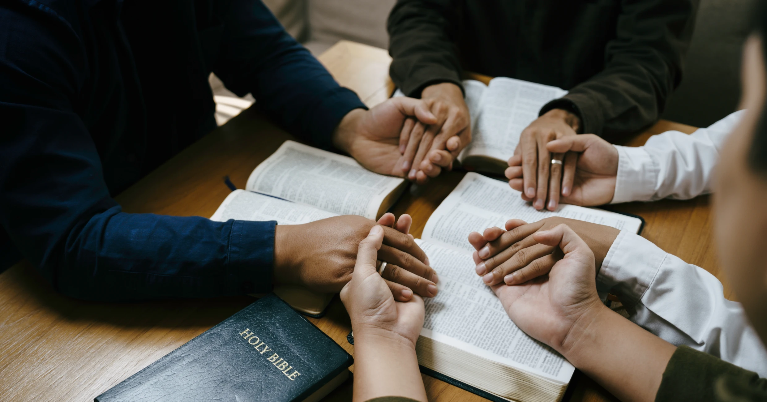 Group holding hands in prayer